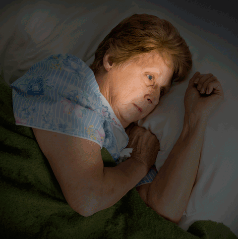 worried woman in bed